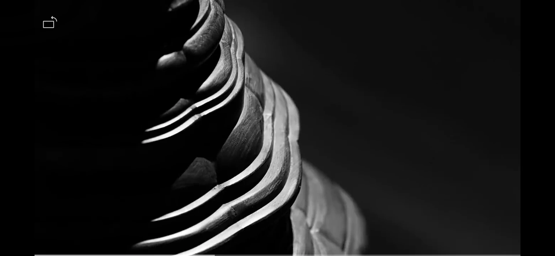Black-and-white sculptural detail with flowing layered edges